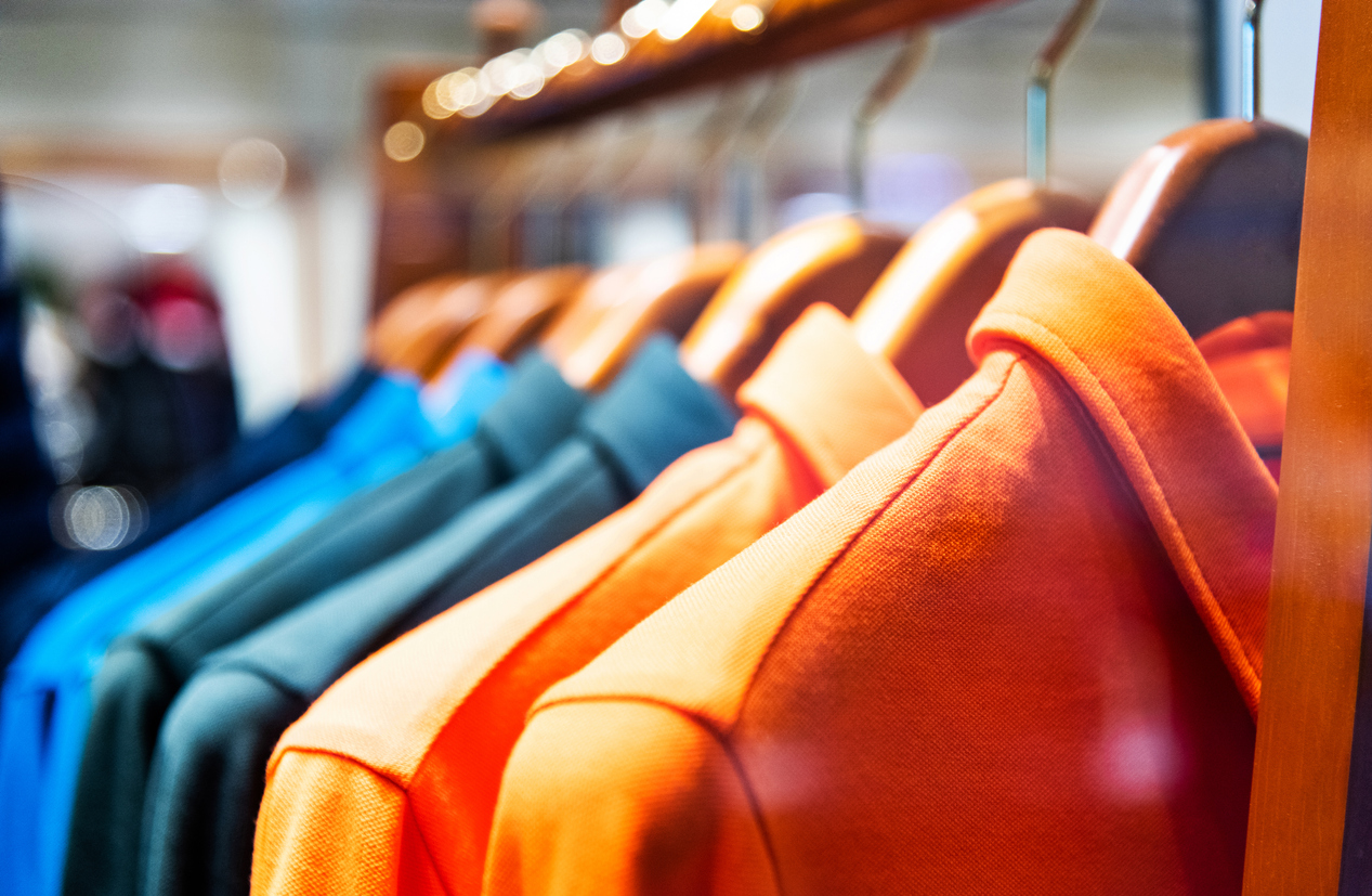 Colorful shirts in modern clothing store.