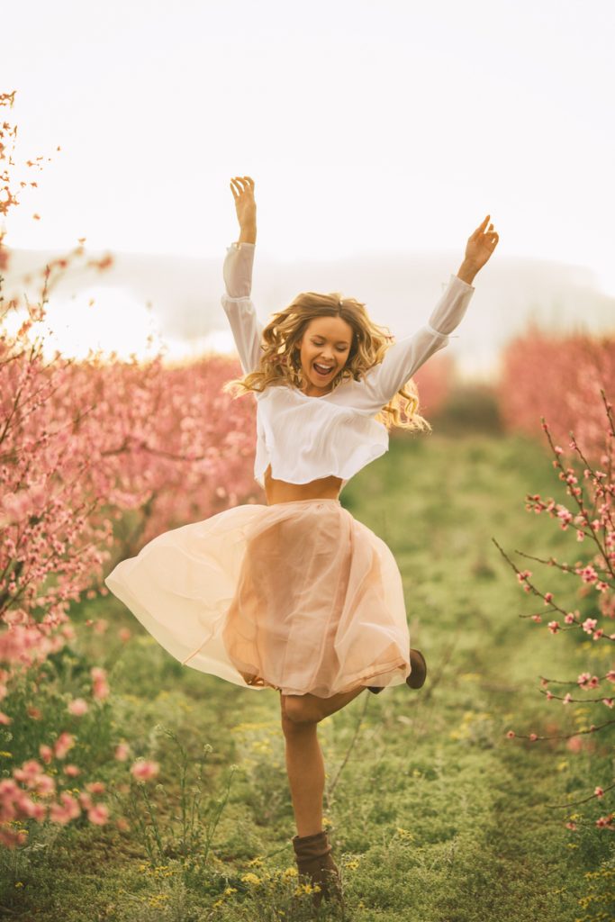 Beautiful young woman with cherry blossom at spring